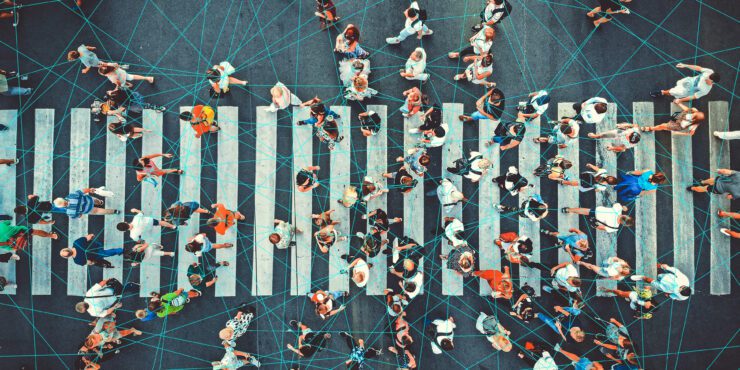 A busy pedestrian crosswalk overlaid with blue interconnecting lines.