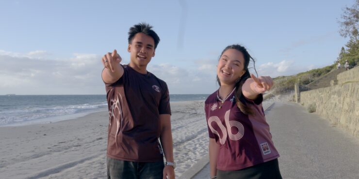 Kristel and Musa pointing at the camera at Cottesloe Beach.