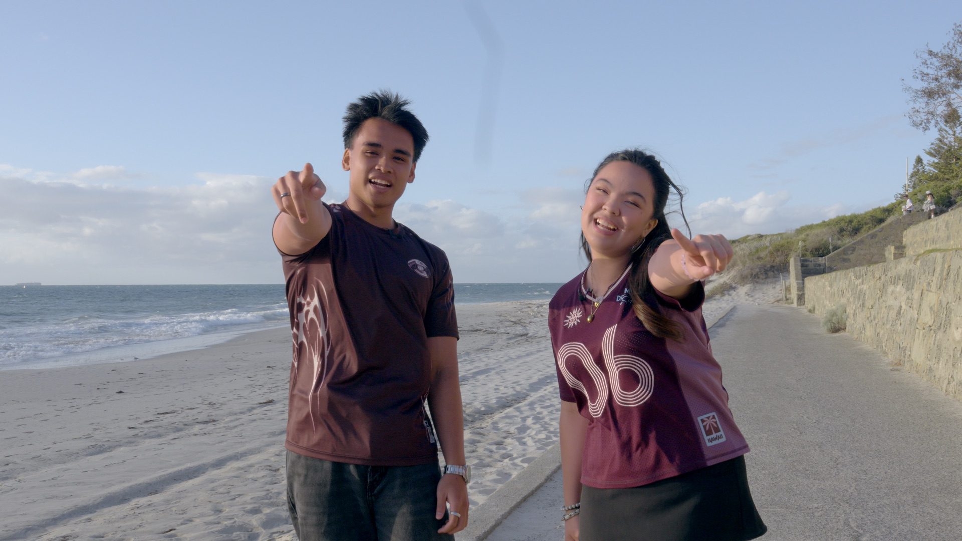 Kristel and Musa pointing at the camera at Cottesloe Beach.