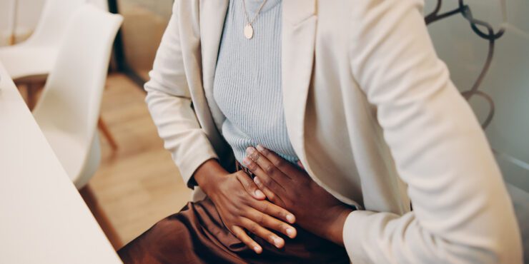 A women holding her stomach in pain