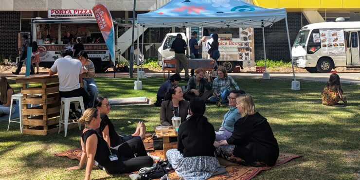 Image of people on a picnic rug at Pop Up Picnic