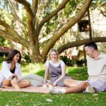 Three students sitting together on campus