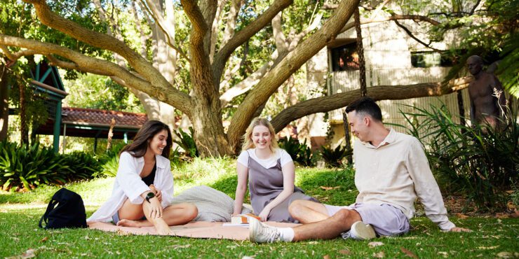 Three students sitting together on campus