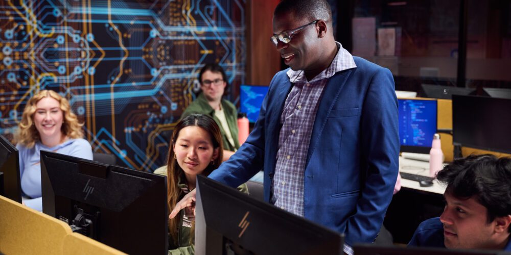 Teacher and students in a computer lab.