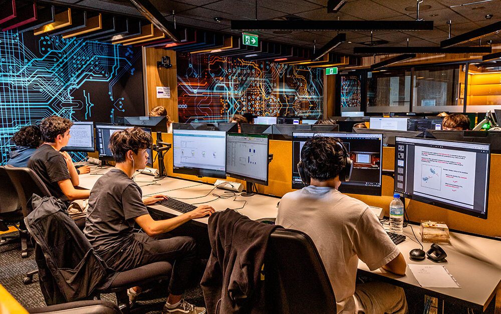 Male students inside a modern computing lab.