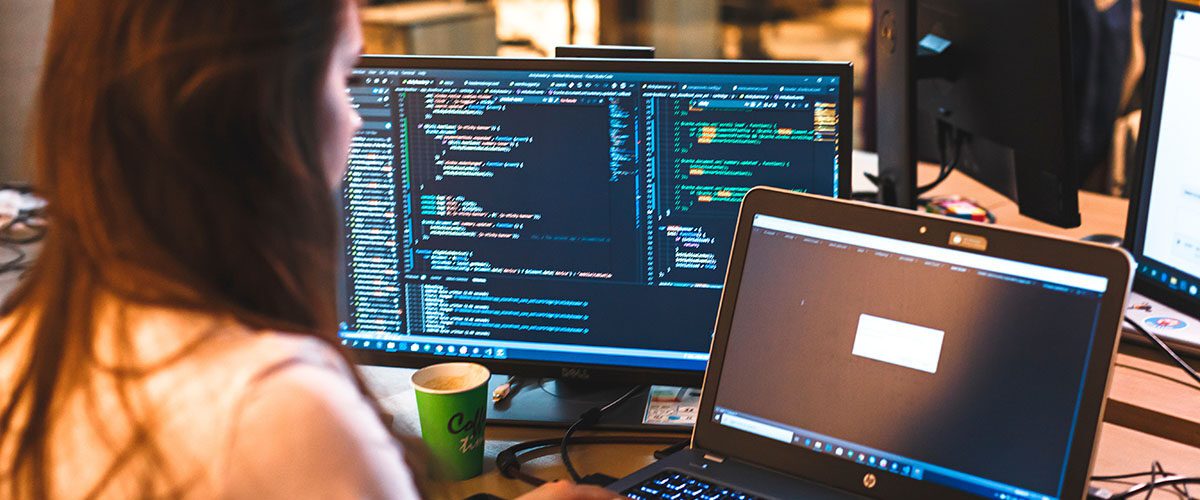 The programmer girl works at the computer