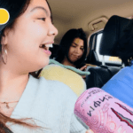 Image of Kristel holding a Monster can with her friends in a car