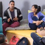 Students seated in a small group discussion during a wellbeing workshop on campus.