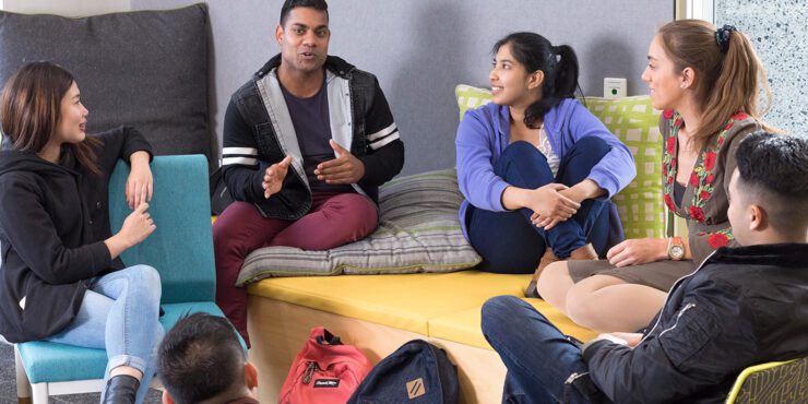 Students seated in a small group discussion during a wellbeing workshop on campus.