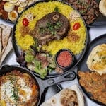 A delicious spread of Middle Eastern halal dishes including lamb and yellow rice, perfect for a vibrant meal.