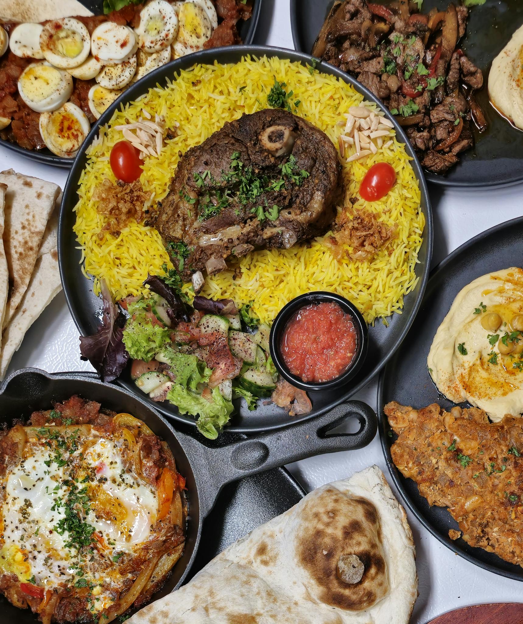 A delicious spread of Middle Eastern halal dishes including lamb and yellow rice, perfect for a vibrant meal.