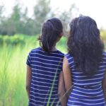 Image of sisters in rural setting.