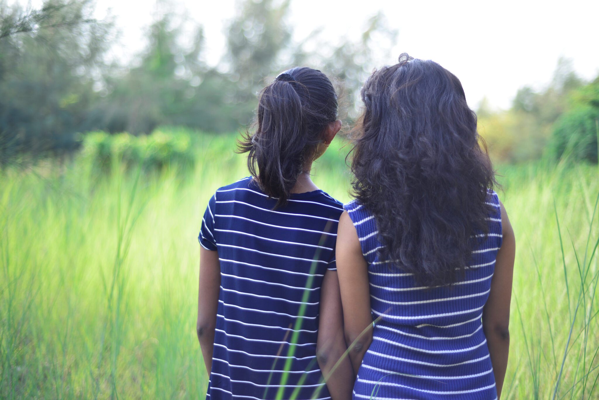 Image of sisters in rural setting.
