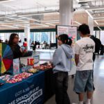 Students at the feedback hub in the Library.
