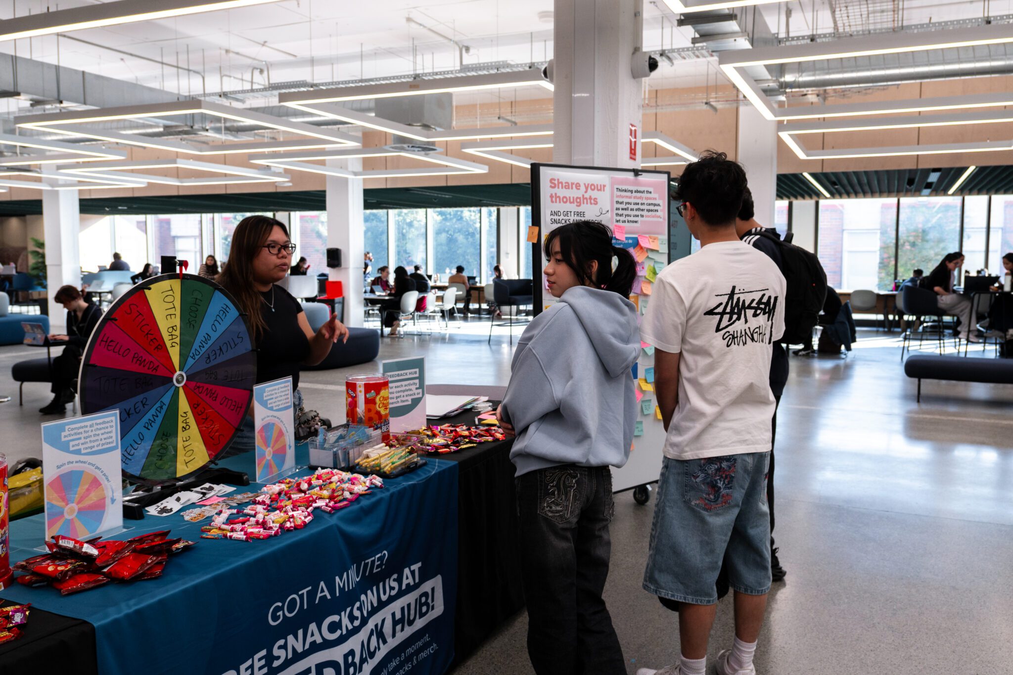 Students at the feedback hub in the Library.
