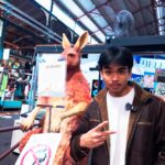Musa standing in front of a taxidermied Kangaroo