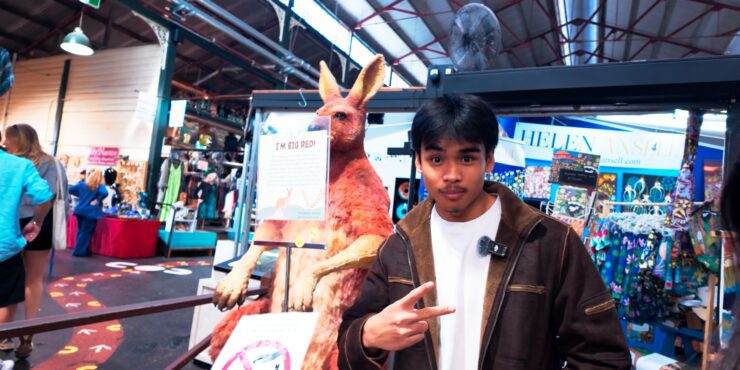 Musa standing in front of a taxidermied Kangaroo