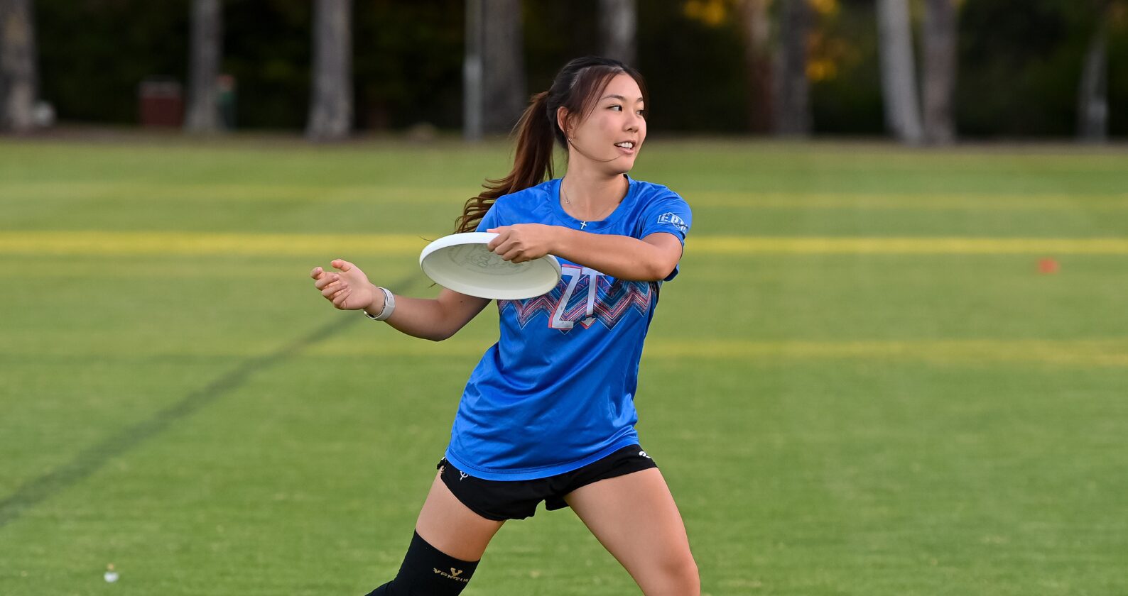 Student playing frisbee