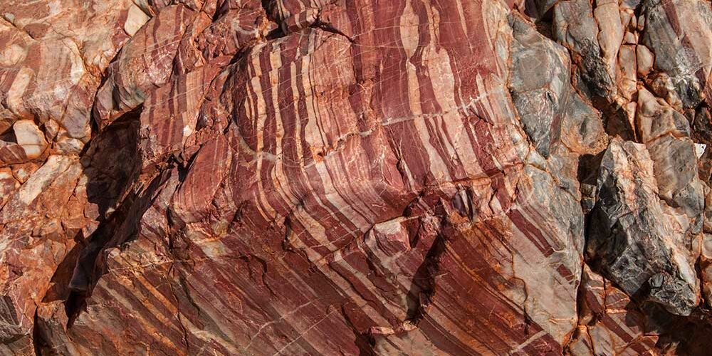 Large reddish brown rock formations with striped details