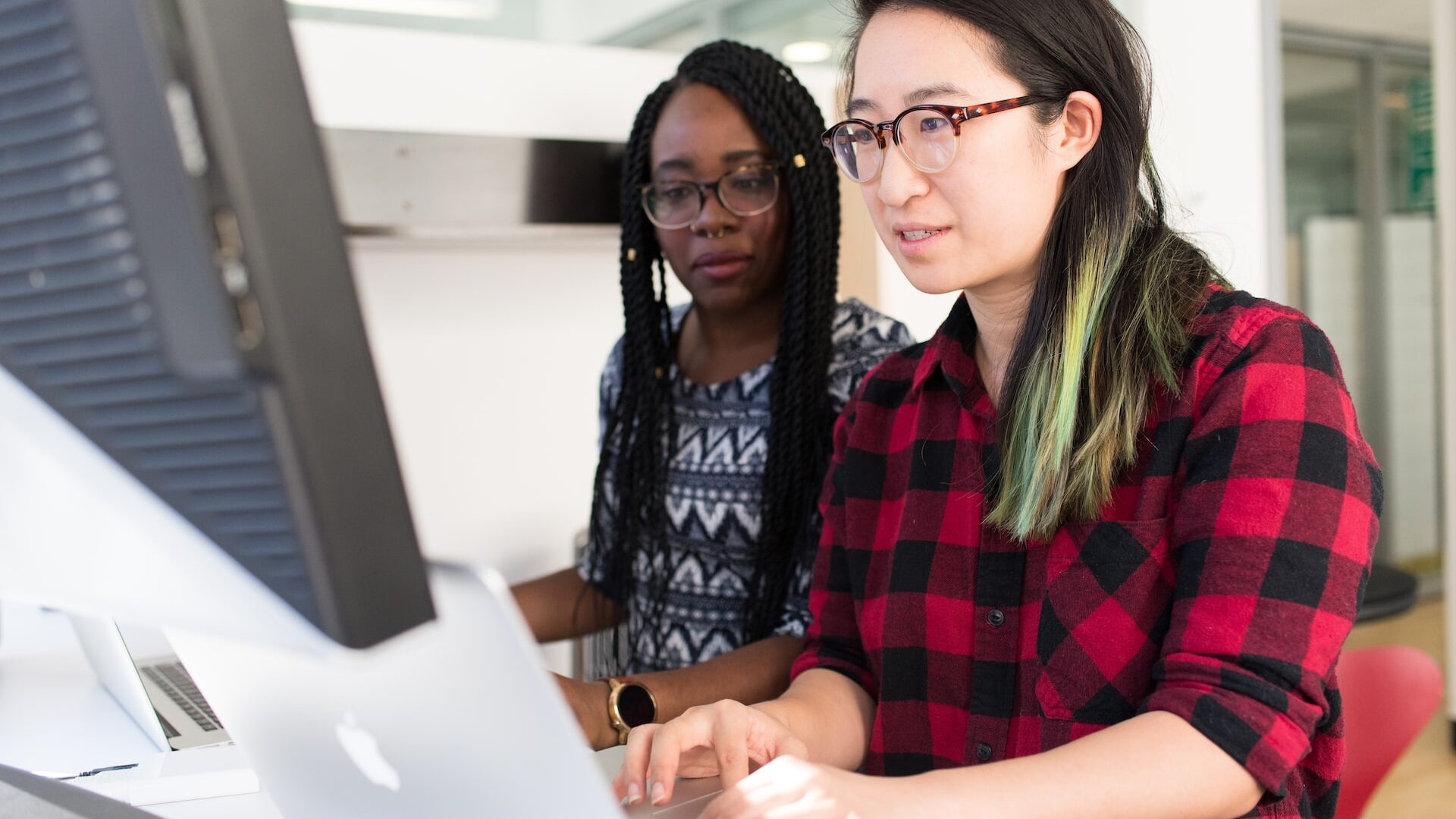 Two students in front of a computer