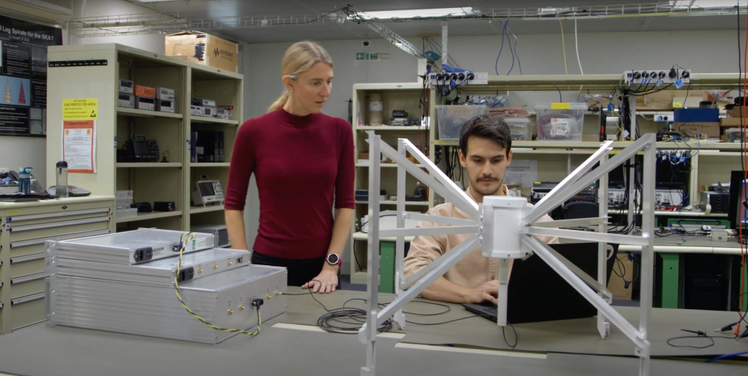 Radio astronomy researchers working on a component of the Murchison Widefield Array - play video