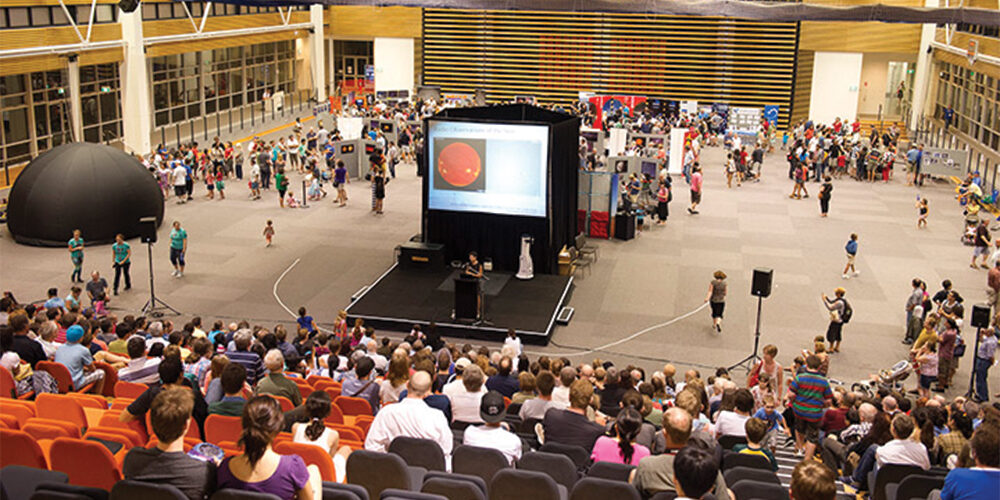 Large arena with people sitting in tiered seating