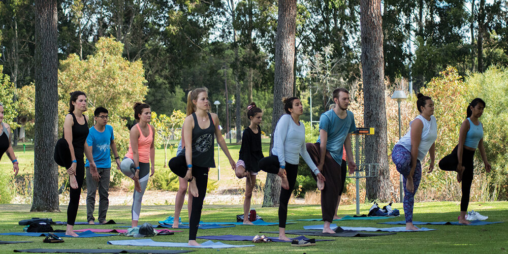 Students attending an outdoor yoga session