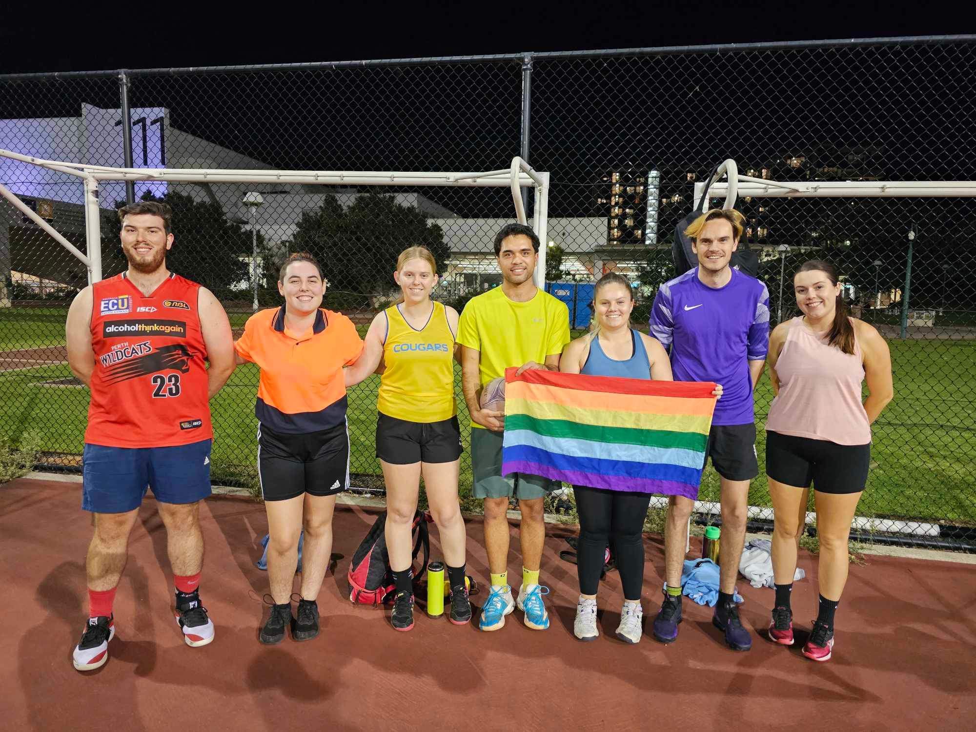 Group of friends holding pride flag