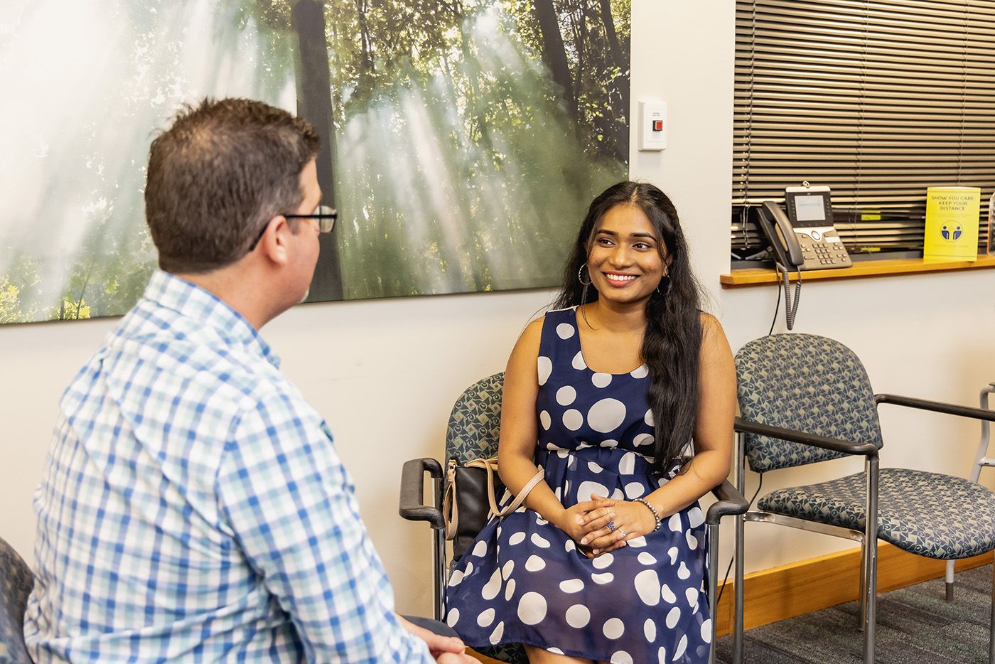 A student smiling at a counsellor