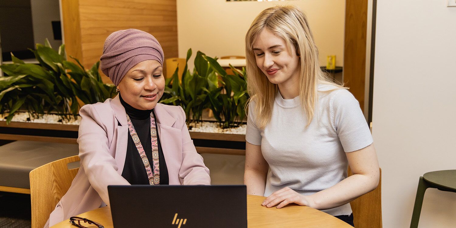 A Curtin employee helping a student