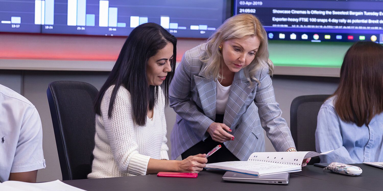 Business women looking at documents