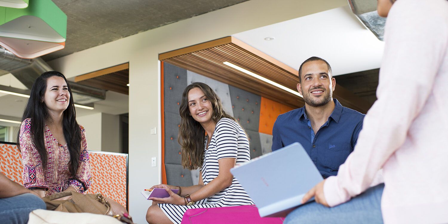 Four people sitting together indoors