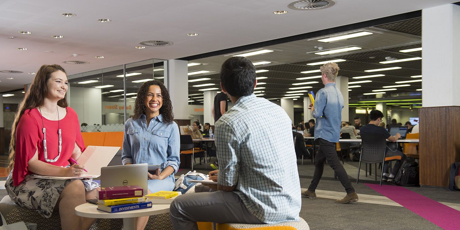 Three students studying in library