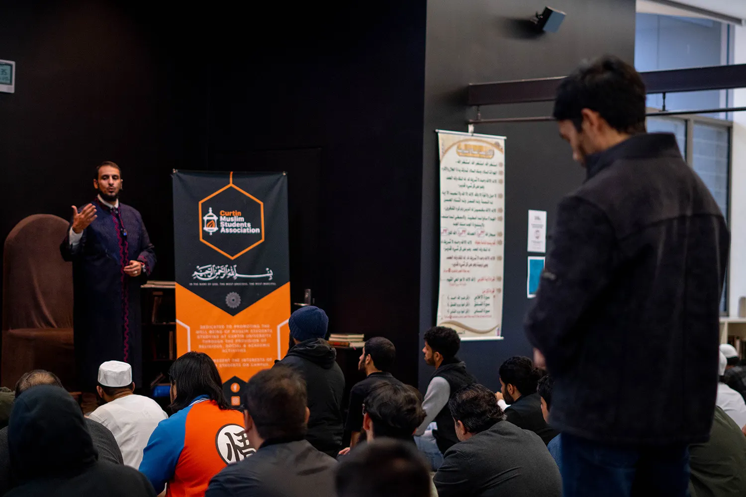 A group of men listening to a talk by Imam Yahya