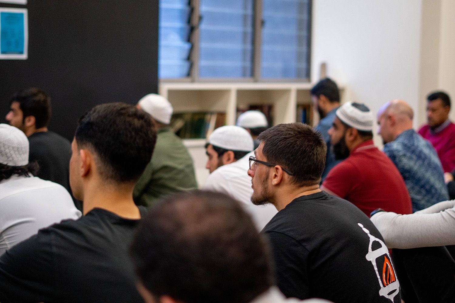 A group of Muslim men listening to a talk - play video