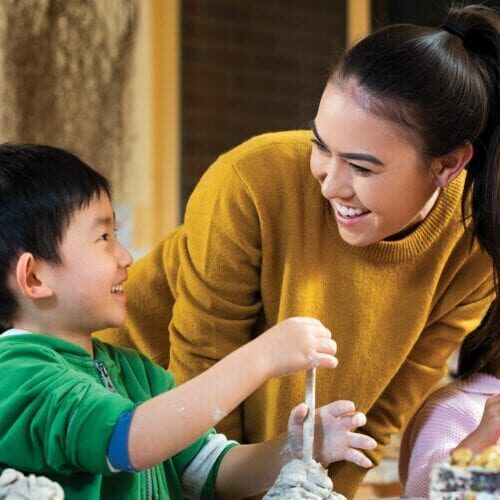 Woman helping a small child