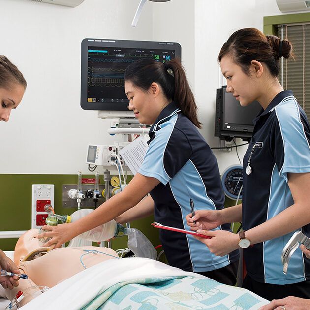 Students performing care on a teaching dummy