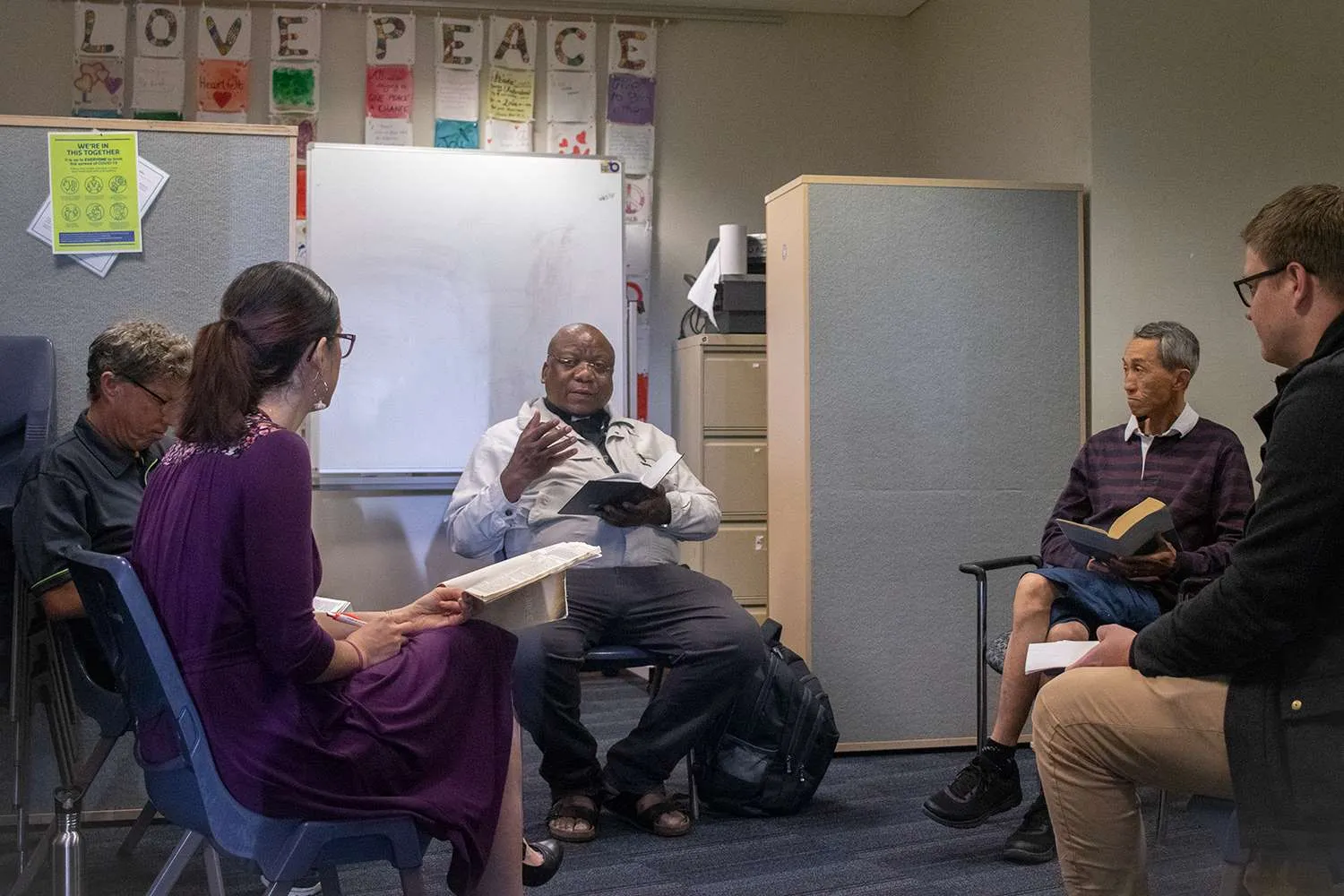 People in a room doing Bible study