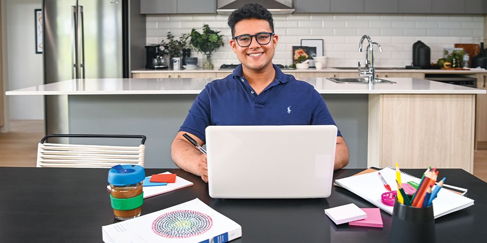 Student studying in the kitchen