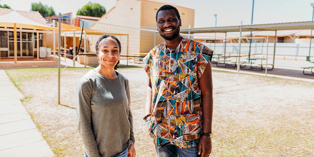 Two students standing outdoors at Kalgoorlie campus.