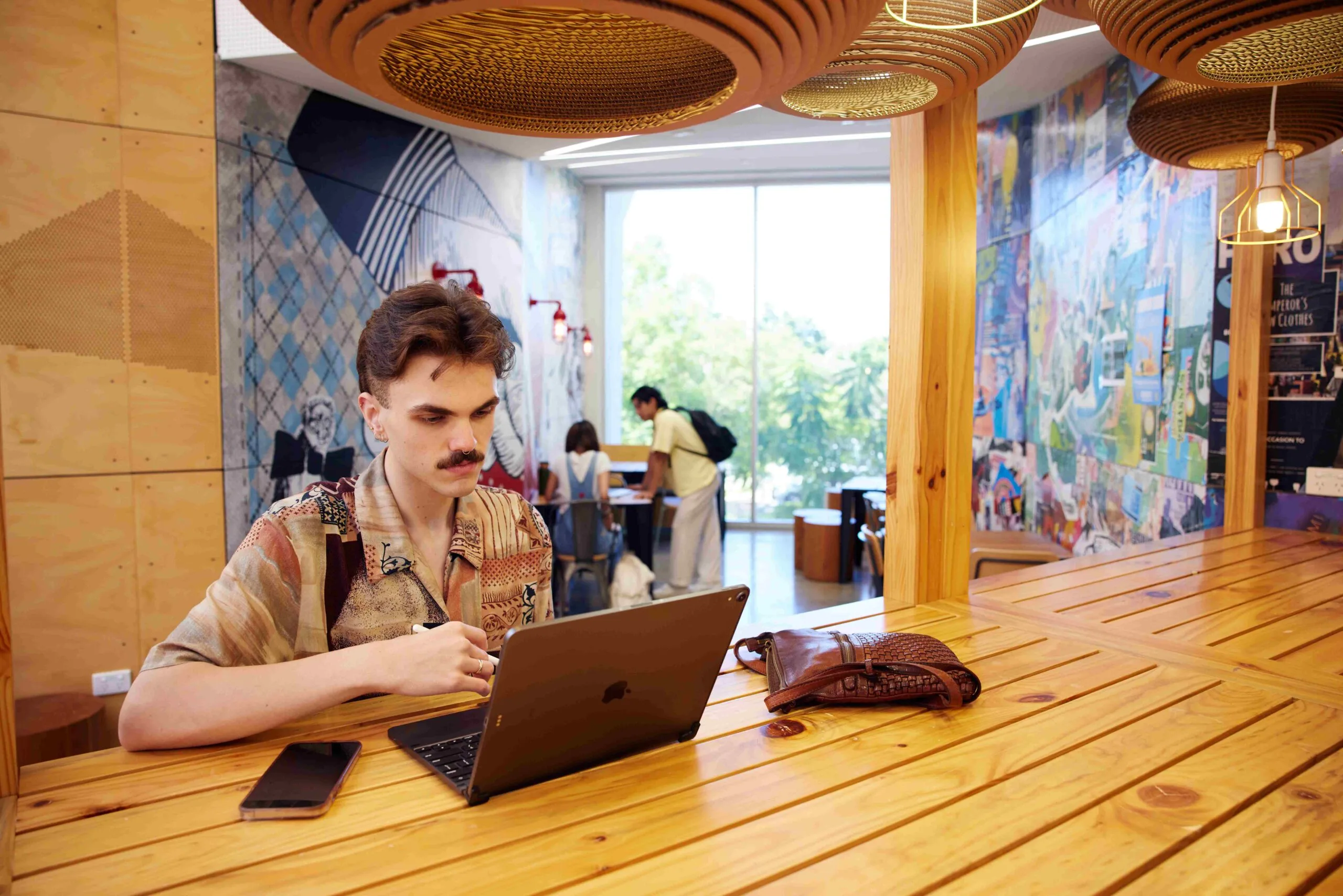 Student uses a laptop whilst being on a laptop