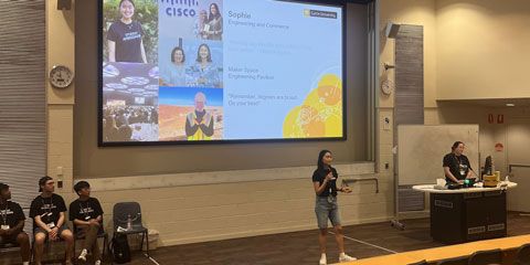 A Student Ambassador standing in front of a large powerpoint.