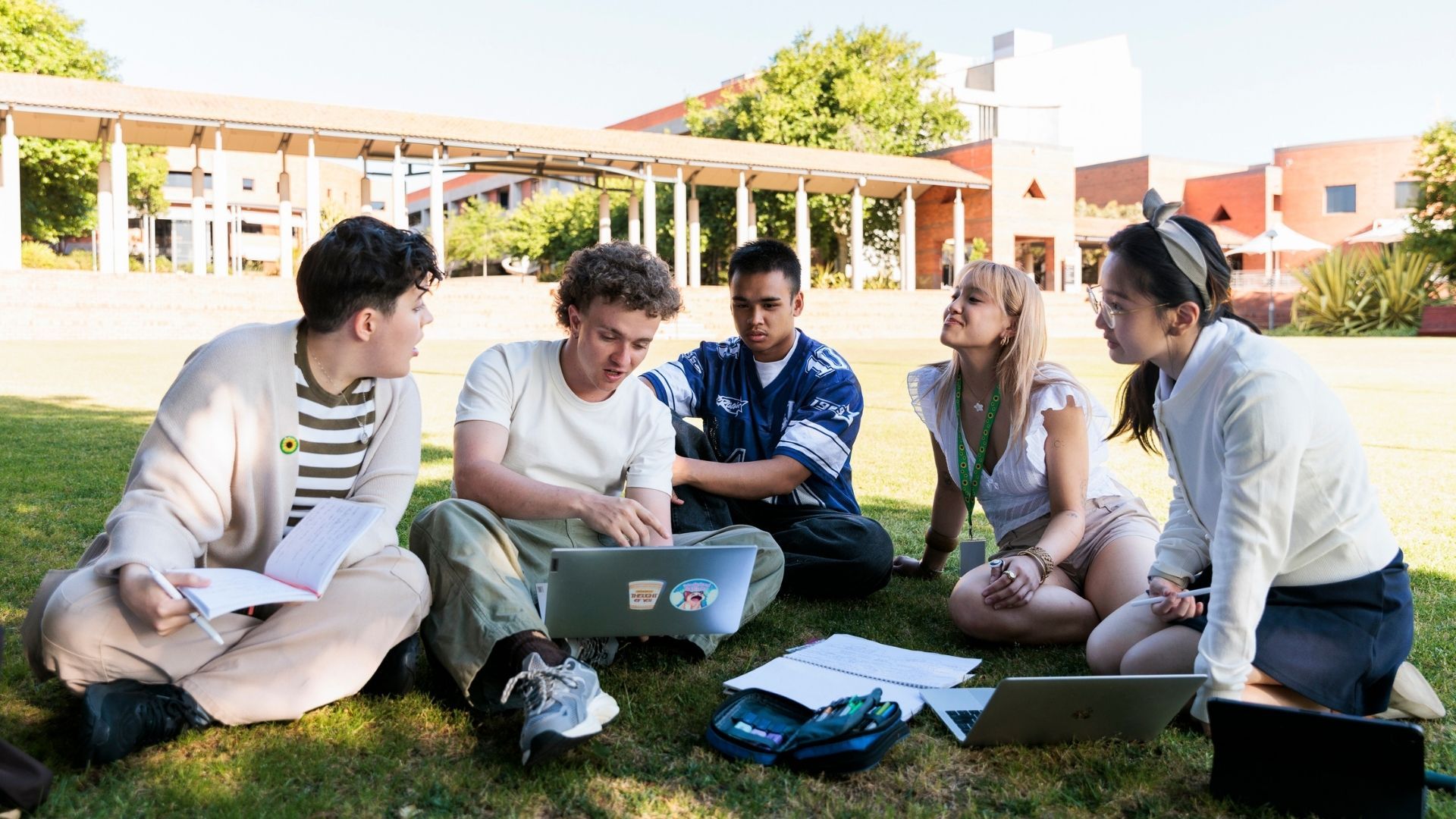 Students sat in a group around a laptop