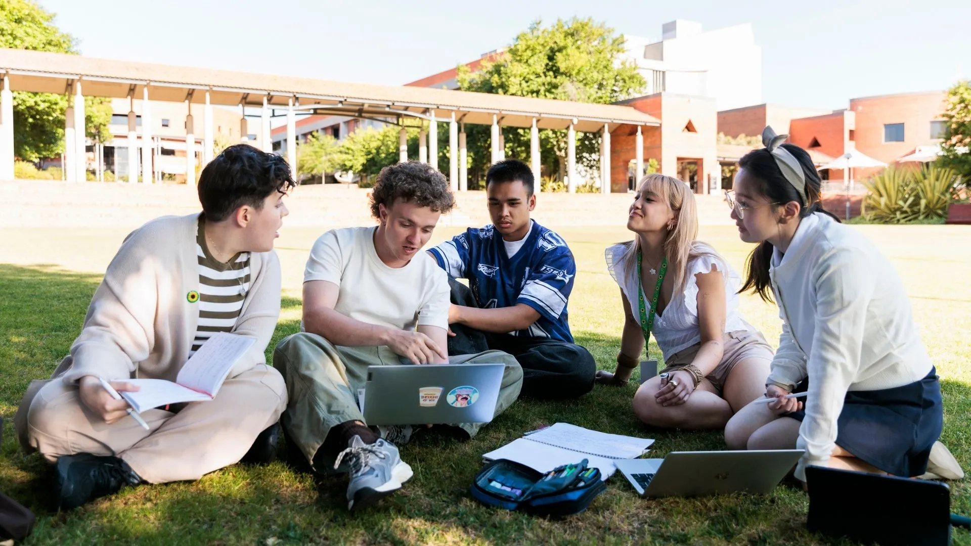 Students sat in a group around a laptop