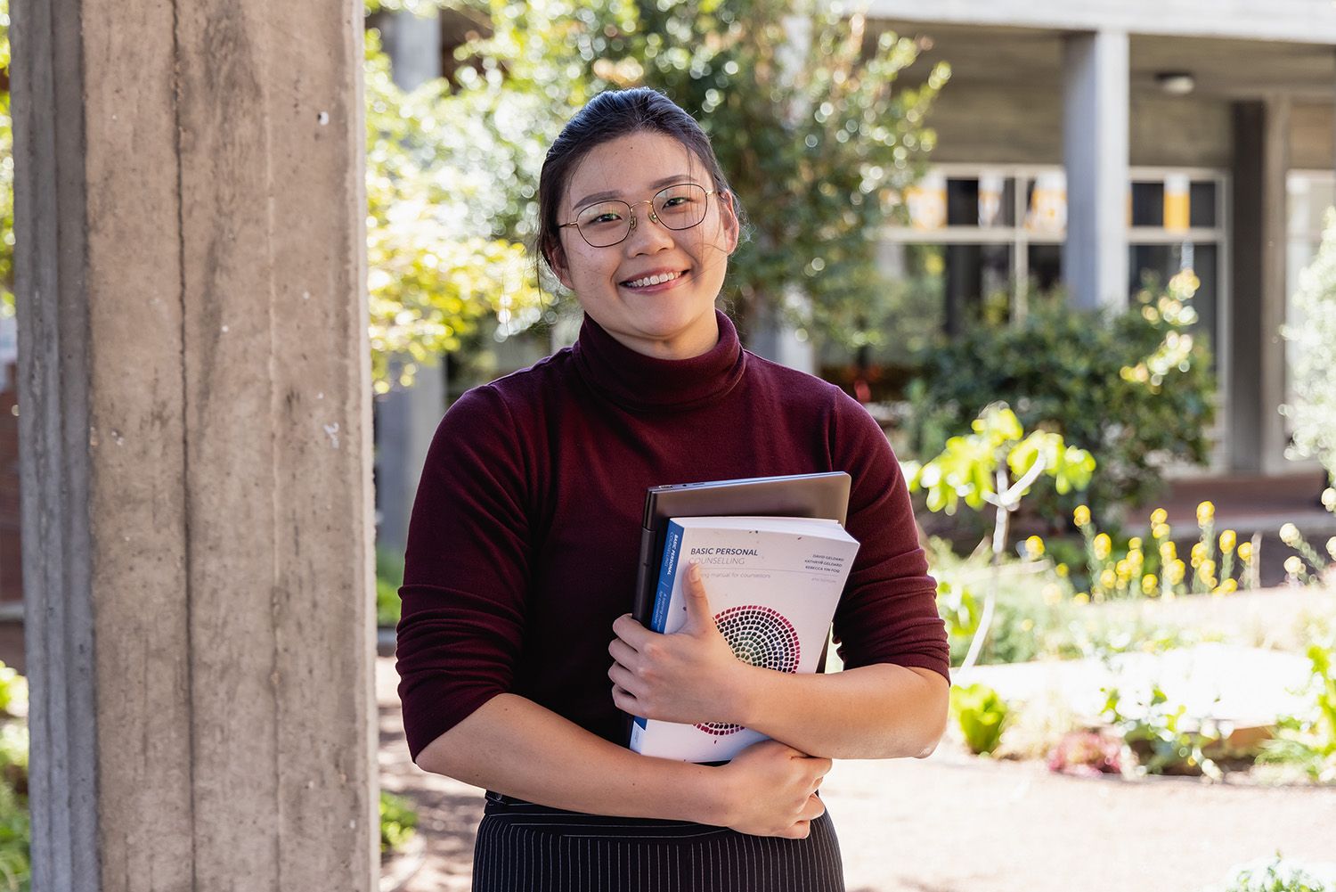 Student stood with books outside