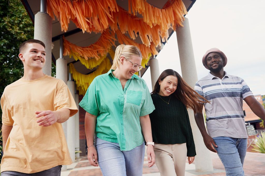 Four students walking outside