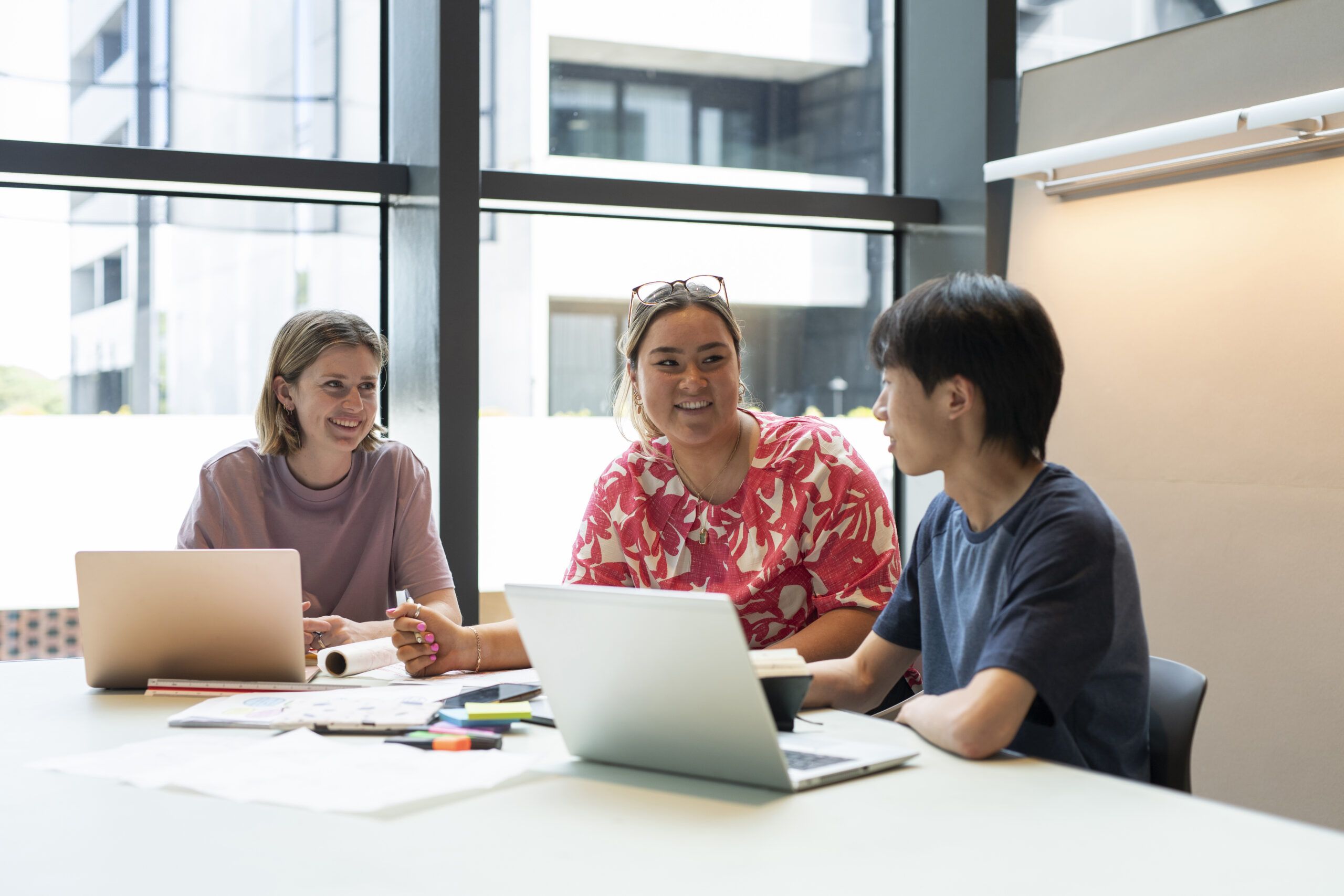 Three Humanities students sat around a table
