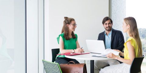 Three students sitting a table collaborating