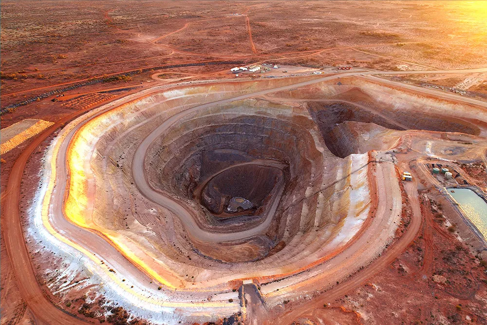 Open cut gold mining operation in remote Australia showing pit and spoil piles