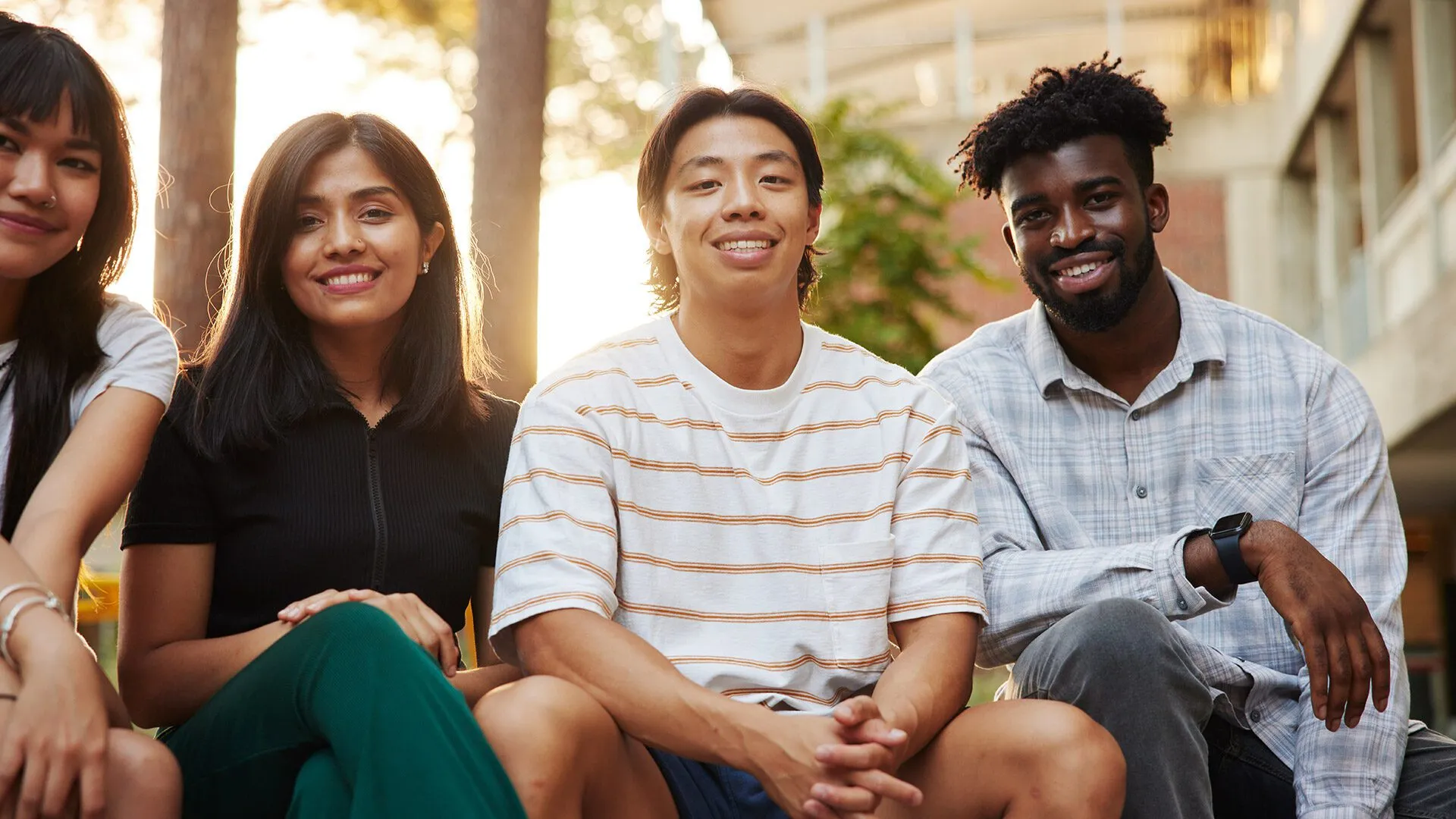 Multicultural students sitting outside